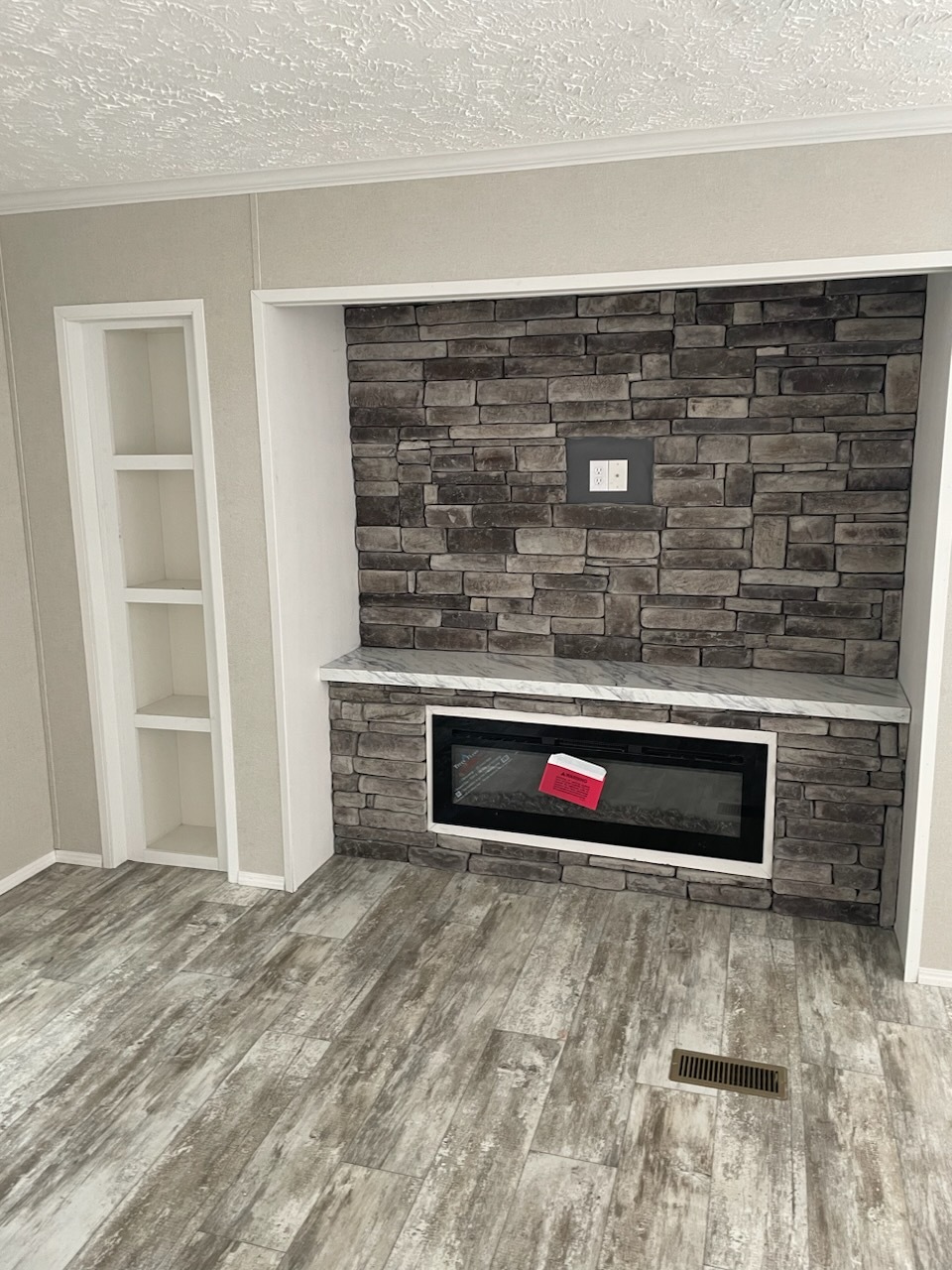 Full Rock entertainment center over electric rock fireplace